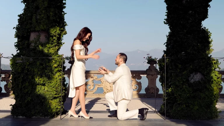 Darren on one knee proposing to Charmaine in the loggia of Villa del Balbianello on Lake Como