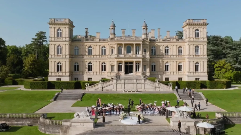 Aerial view of Château de Ferrières near Paris with the outdoor wedding ceremony on the lawn