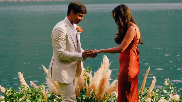 Groom placing the engagement ring on his fiancée during an Indian wedding proposal at Villa La Cassinella on Lake Como