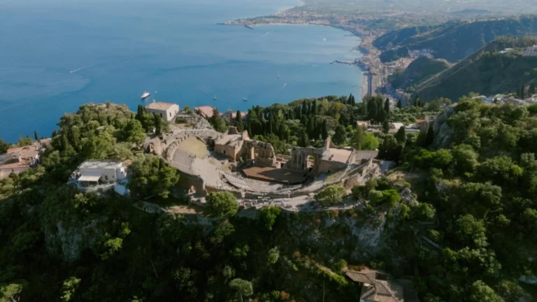 Aerial view of Taormina in Sicily with the Greek Theatre and the bay, location of Lauren and Alex wedding