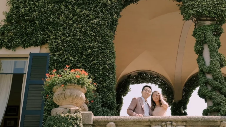 Engaged couple in the ivy-covered loggia of Villa del Balbianello on Lake Como